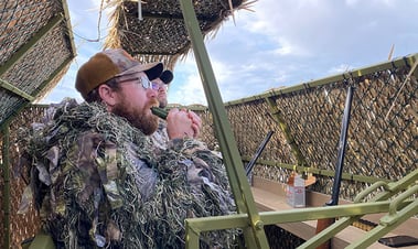 hunter inside blind calling ducks