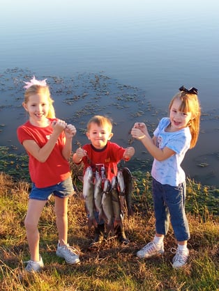 kids holding catfish stringer
