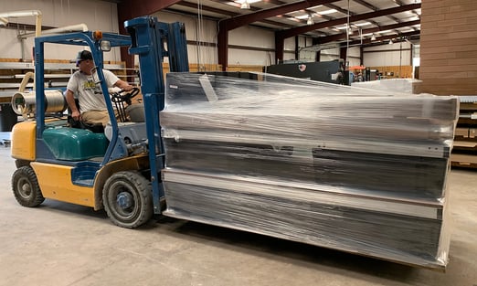 forklift hauling dock on pallet