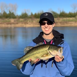 Woman holding trophy-class bass