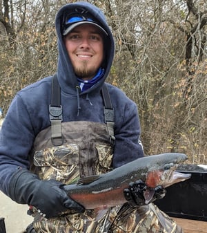 Man-holding-rainbow-trout