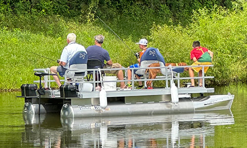 Family fishing on small pontoon boat