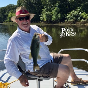 man fishing on small pontoon boat