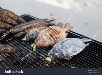 stock-photo-hot-grill-fishes-such-as-catfishes-and-nile-tilapias-on-the-mesh-448563304