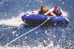 kids tubing on water