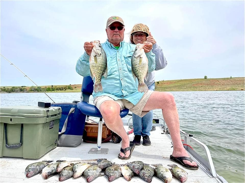 Couple crappie fishing on pontoon boat