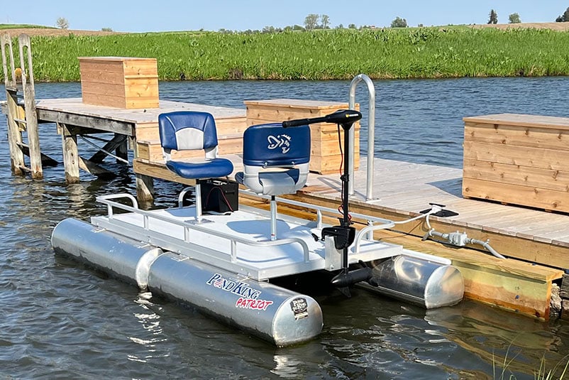 Pond King Patriot small boat tied up next to dock